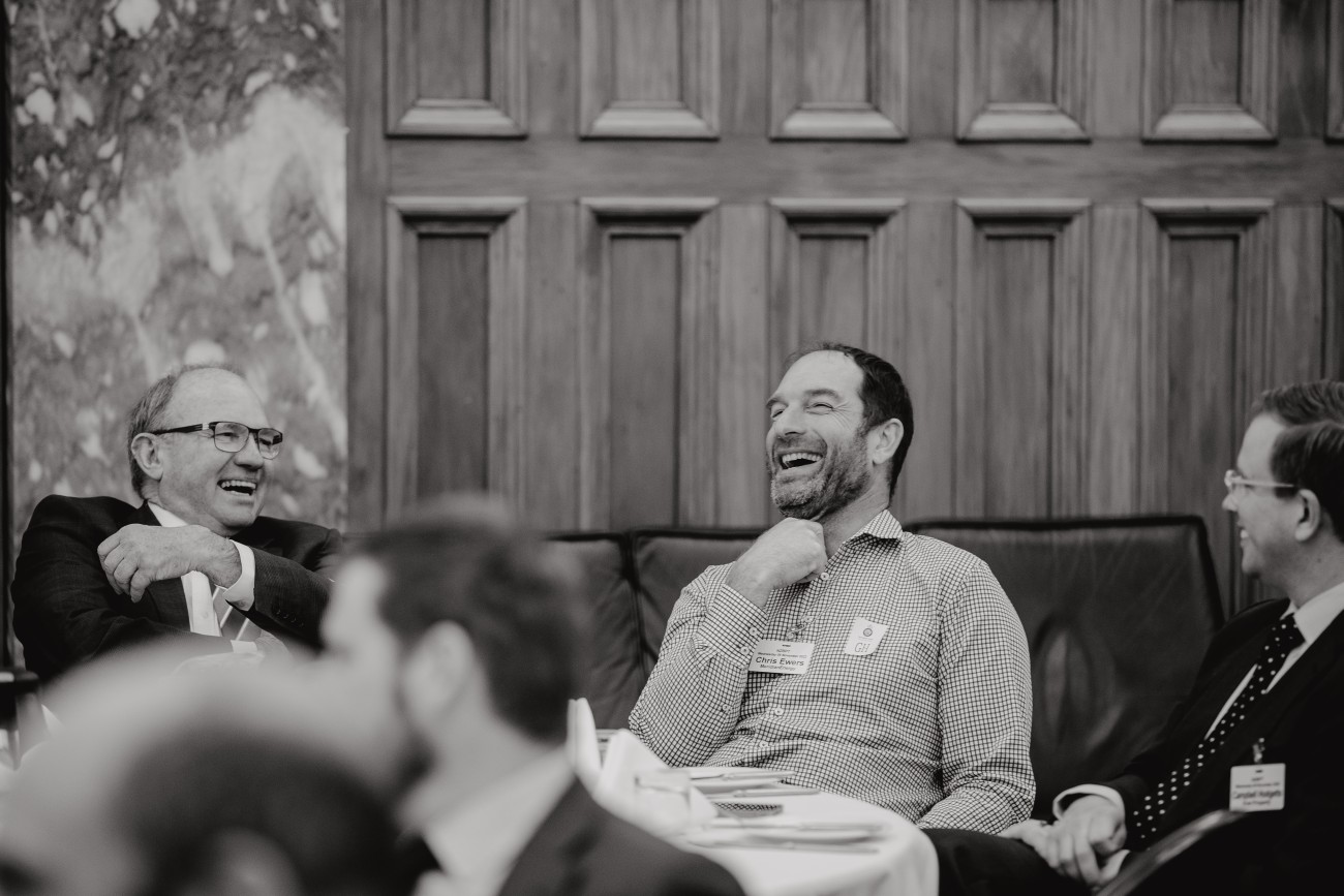 black and white parliamentary seminar attendees smile